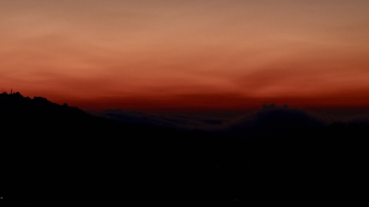 Dusk sky over dark mountain silhouette